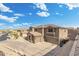 Aerial view of a stucco home featuring large garage, stone accents and basketball hoop, situated in a neighborhood at 6202 W Maya Dr, Phoenix, AZ 85083