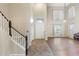 Foyer featuring high ceilings, wood floors, a staircase, and a grand entrance with natural light at 6202 W Maya Dr, Phoenix, AZ 85083