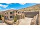 Two-story home featuring desert landscaping, and a concrete driveway that goes up a small hill at 6202 W Maya Dr, Phoenix, AZ 85083