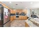 Well-equipped kitchen with stainless steel appliances, wooden cabinets, and tile floors at 6202 W Maya Dr, Phoenix, AZ 85083
