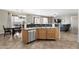 Kitchen island features a stainless steel dishwasher and sink with space to eat in adjacent room at 6202 W Maya Dr, Phoenix, AZ 85083