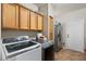 Laundry room with upper cabinets, washer and dryer, and stainless steel refrigerator at 6202 W Maya Dr, Phoenix, AZ 85083