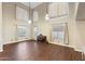 Bright living room with high ceilings, hardwood floors, a piano, and many windows for natural light at 6202 W Maya Dr, Phoenix, AZ 85083