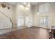 Living room with hardwood floors, a staircase, and tall ceilings at 6202 W Maya Dr, Phoenix, AZ 85083