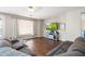 Cozy living room with hardwood floors, comfortable seating, and a television for entertainment at 6202 W Maya Dr, Phoenix, AZ 85083