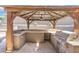 A built-in grill, sink, and counter tops provide an attractive outdoor kitchen and bar area at 6202 W Maya Dr, Phoenix, AZ 85083