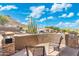 Outdoor patio with patio seating, desert landscaping, mountain views and a clear blue sky at 6202 W Maya Dr, Phoenix, AZ 85083