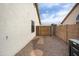 Enclosed backyard with a stone walkway and gravel landscaping, creating a private outdoor space at 6366 W Saint John Ave, Glendale, AZ 85308