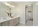 Bathroom featuring a double vanity, neutral colors, and a separate shower at 6366 W Saint John Ave, Glendale, AZ 85308