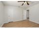 This well-lit bedroom boasts modern flooring, a ceiling fan, and an adjacent closet for comfort and convenience at 6366 W Saint John Ave, Glendale, AZ 85308