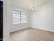 Elegant dining area with hardwood floors, large window, and modern chandelier at 6366 W Saint John Ave, Glendale, AZ 85308