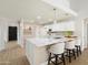 Bright open kitchen with white cabinets, quartz countertops, stainless appliances, and island seating at 6366 W Saint John Ave, Glendale, AZ 85308