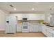 Bright kitchen featuring white cabinets, modern appliances, and stone backsplash at 6366 W Saint John Ave, Glendale, AZ 85308