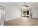 Bright living room boasts vaulted ceilings, fan, and sliding doors to pool area at 6366 W Saint John Ave, Glendale, AZ 85308