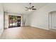 Bright living room boasts vaulted ceilings, fan, and sliding doors to patio seating at 6366 W Saint John Ave, Glendale, AZ 85308