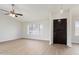 Bright living room featuring wood-look flooring, neutral walls, and natural light from large windows at 6366 W Saint John Ave, Glendale, AZ 85308