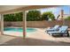 Inviting backyard pool area with comfortable lounge chairs under a covered patio at 6366 W Saint John Ave, Glendale, AZ 85308