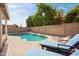 Relaxing pool area featuring chairs, landscaping, and a clear blue pool, perfect for outdoor enjoyment and leisure at 6366 W Saint John Ave, Glendale, AZ 85308