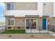 Modern townhome with brick accents, fenced patio, and stylish blue door at 651 N Ironwood Dr # 8, Apache Junction, AZ 85120