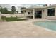 Resort-style backyard with a shimmering pool, expansive travertine patio, and comfortable seating area at 6529 E Eugie Ter, Scottsdale, AZ 85254