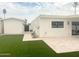 Backyard featuring lush green lawn, travertine patio, modern exterior, and potential for outdoor enjoyment at 6529 E Eugie Ter, Scottsdale, AZ 85254