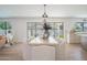 Modern dining room with backyard view, contemporary light fixture, and seating for six at 6529 E Eugie Ter, Scottsdale, AZ 85254