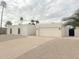 Contemporary white home with a two-car garage, desert landscaping, and a private courtyard at 6529 E Eugie Ter, Scottsdale, AZ 85254
