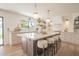 Bright kitchen featuring a large island with seating, custom cabinetry, and stylish pendant lighting at 6529 E Eugie Ter, Scottsdale, AZ 85254