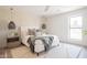 Bright main bedroom with modern lighting, a ceiling fan, and a large window at 6529 E Eugie Ter, Scottsdale, AZ 85254