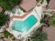 Aerial view of a sparkling community pool with tiled roof seating area, surrounded by lush landscaping at 6533 N 7Th Ave # 18, Phoenix, AZ 85013