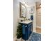 Chic powder room features designer mirror, blue vanity with marble counter, and stylish lighting at 6533 N 7Th Ave # 18, Phoenix, AZ 85013
