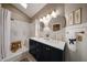 Stylish bathroom featuring a double vanity, modern lighting, and a luxurious walk-in shower with elegant fixtures at 6533 N 7Th Ave # 18, Phoenix, AZ 85013
