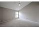 Bedroom with vaulted ceilings, ceiling fan, and large window with plantation shutters at 6533 N 7Th Ave # 18, Phoenix, AZ 85013