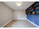 Spacious bedroom with blue tile accent wall and shelving, features wood-look tile flooring at 6533 N 7Th Ave # 18, Phoenix, AZ 85013