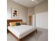Bright bedroom with a minimalist design, natural light, and wooden bedframe at 6533 N 7Th Ave # 18, Phoenix, AZ 85013