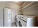 Bright laundry room with included washer, dryer, shelving, and water heater at 6533 N 7Th Ave # 18, Phoenix, AZ 85013