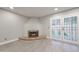 Bright living room with corner fireplace and French doors to the backyard at 6533 N 7Th Ave # 18, Phoenix, AZ 85013