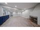 Spacious living area with wood-look floors, a fireplace, and blue accent cabinets for extra storage at 6533 N 7Th Ave # 18, Phoenix, AZ 85013