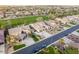 Aerial shot of beautiful homes showcasing well-manicured lawns and neighborhood backing onto a lush green golf course at 654 E County Down Dr, Chandler, AZ 85249