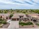 Expansive home featuring a three-car garage, lush landscaping, and a well-maintained lawn in a golf course community at 654 E County Down Dr, Chandler, AZ 85249