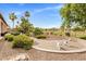 Serene backyard oasis with lush landscaping, a cozy patio, and golf course views, perfect for outdoor entertaining at 654 E County Down Dr, Chandler, AZ 85249