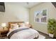 Bright bedroom with natural light, wood bed frame, and bedside tables, creating a cozy and inviting atmosphere at 654 E County Down Dr, Chandler, AZ 85249