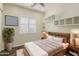 Cozy bedroom features a wood bed frame, decorative wall art, and bright natural light from the window at 654 E County Down Dr, Chandler, AZ 85249