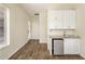 Bonus room features built-in wet bar with mini fridge and white shaker cabinets at 654 E County Down Dr, Chandler, AZ 85249
