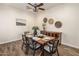 An elegant dining room showcasing a wooden table, ceiling fan, and lovely decorative accents at 654 E County Down Dr, Chandler, AZ 85249