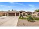 Attractive home with three-car garage, desert landscaping, and covered entry at 654 E County Down Dr, Chandler, AZ 85249
