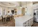 Modern kitchen with a large island, stainless steel appliances, and an open view to the living room at 654 E County Down Dr, Chandler, AZ 85249