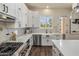 Modern kitchen featuring white cabinets, stainless steel appliances and a farmhouse sink at 654 E County Down Dr, Chandler, AZ 85249
