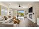 Spacious living room with stone fireplace, hardwood floors, and sliding glass doors to the backyard at 654 E County Down Dr, Chandler, AZ 85249