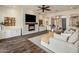 Open-concept living room features a stone fireplace, hardwood floors, and neutral decor at 654 E County Down Dr, Chandler, AZ 85249